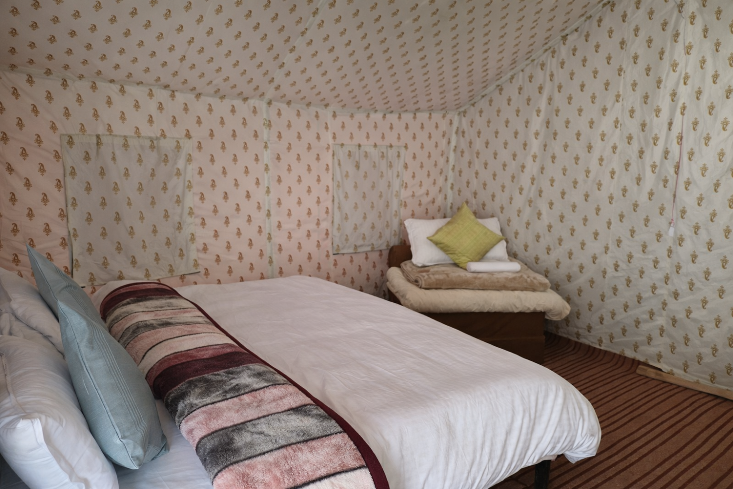 Deluxe Swiss tent at Himalayan Routes Sarchu featuring attached washroom, clean white linens.